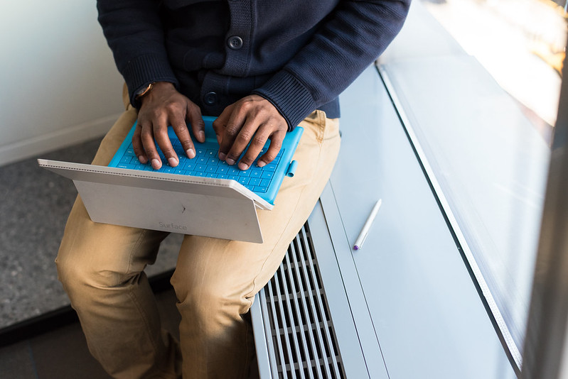 Black writer working on a Surface computer